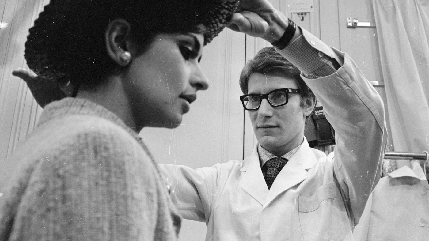 Yves Saint Laurent works with a model at his Paris fashion house in 1965. A new film follows the designer's rise in the fashion world.