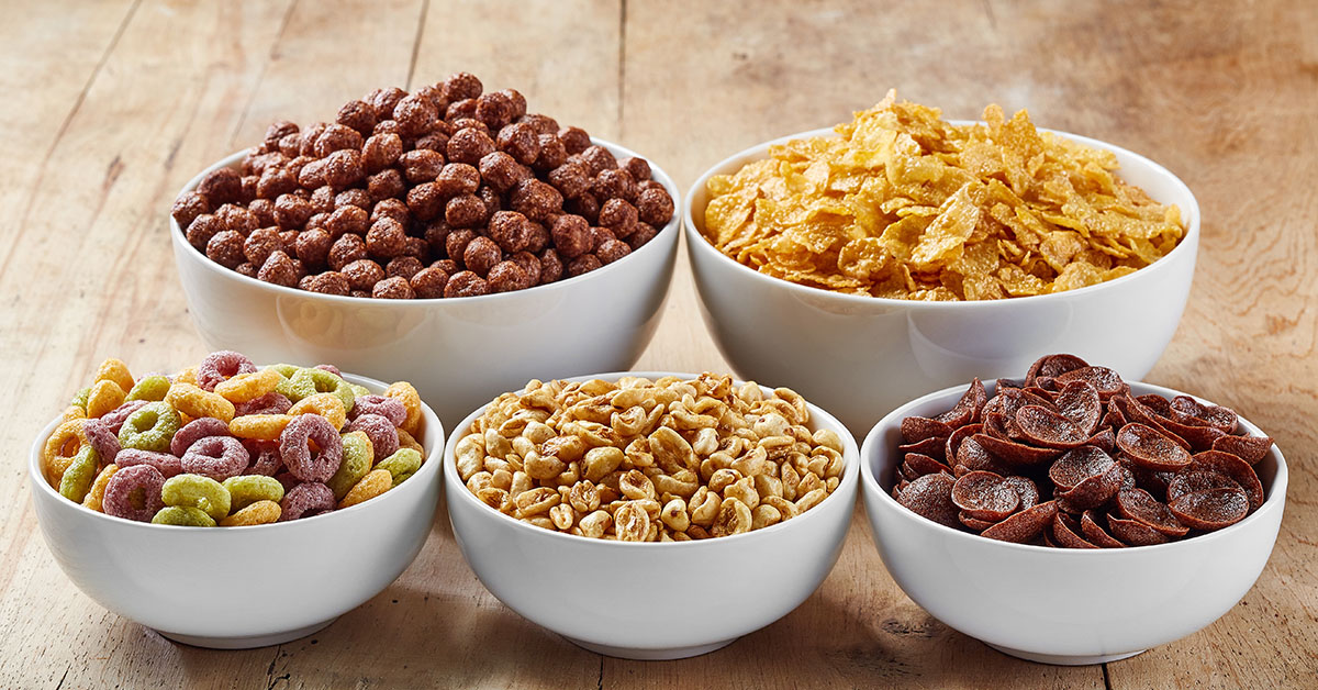 Bowls of various cereals on wooden background